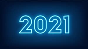 A landscape image of the number (and year) 2021. The background is dark blue and the numbers are in a neon white.
