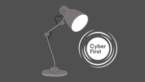 A lamp and a NCSC’s CyberFirst scheme logo on a dark background